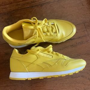 Yellow Reebok tennis shoes